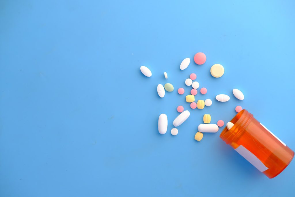 Pills Spilled on blue background